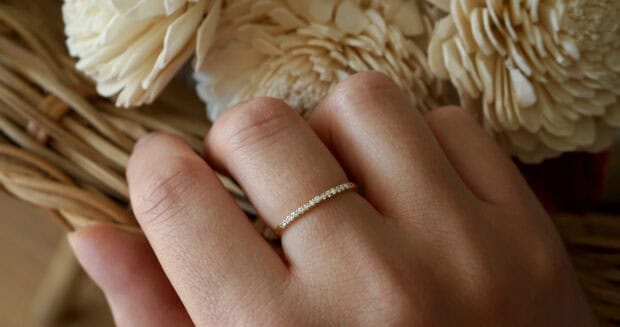 A close up of a hand wearing a delicate gold ring with small diamonds, HD Desktop Wallpaper