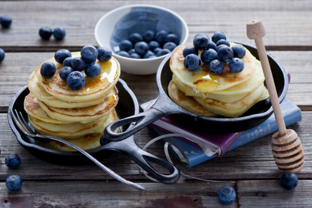 A stack of pancakes with fresh blueberries and honey dripping on a wooden table, HD Desktop Wallpaper