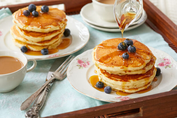 A stack of pancakes with syrup and fresh blueberries served on fine china, HD Desktop Wallpaper