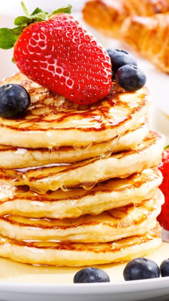 A stack of pancakes topped with strawberry and blueberries drizzled with syrup, 4K Mobile Wallpaper