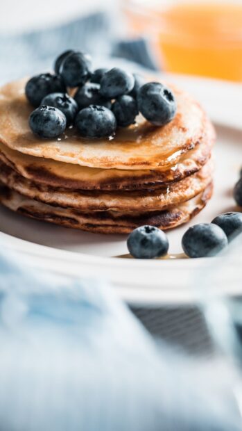 A close up of pancakes topped with fresh blueberries and syrup on a plate, HD Mobile Wallpaper