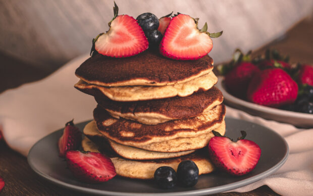 A stack of pancakes topped with strawberries and blueberries on a plate, 2K Desktop Wallpaper