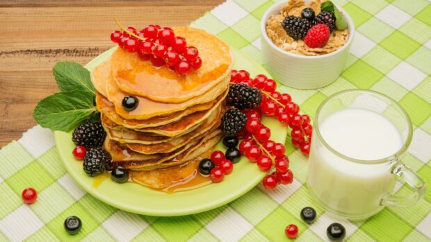 A stack of pancakes with syrup and fresh berries on a plate, 4K Desktop Wallpaper