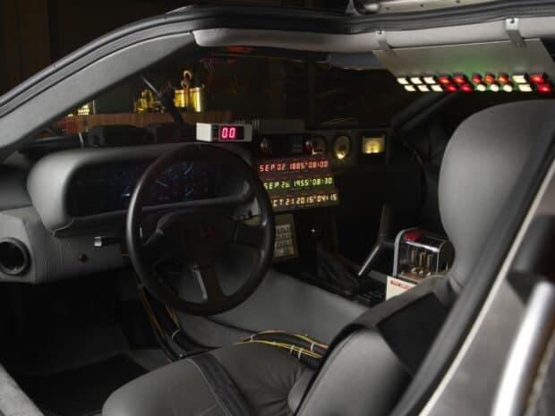 The Delorean Dmc 12 dashboard features a complex time travel control panel with illuminated buttons, HD Desktop Wallpaper