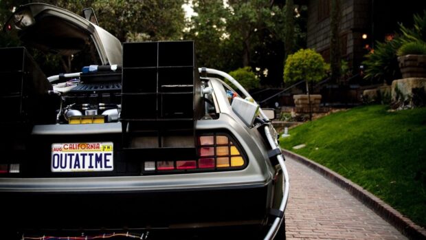 The Delorean Dmc 12 car with an open trunk is parked outdoors on a brick path, HD Desktop Wallpaper