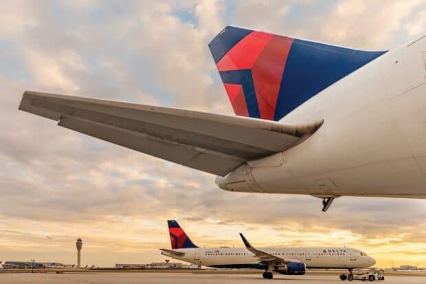 Delta Air Lines planes parked on the tarmac under a cloudy sky, HD Desktop Wallpaper