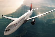 A Delta Air Lines airplane soars above a scenic coastline during sunset in this Delta Air Lines Wallpapers, HD Desktop Wallpaper PC Wallpaper