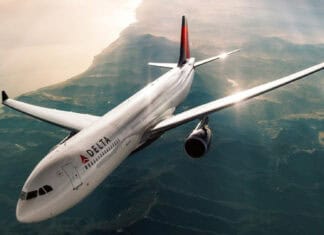 A Delta Air Lines airplane soars above a scenic coastline during sunset in this Delta Air Lines Wallpapers, HD Desktop Wallpaper PC Wallpaper