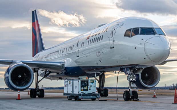 A Delta Air Lines airplane is parked on the runway with ground equipment nearby, HD Desktop Wallpaper
