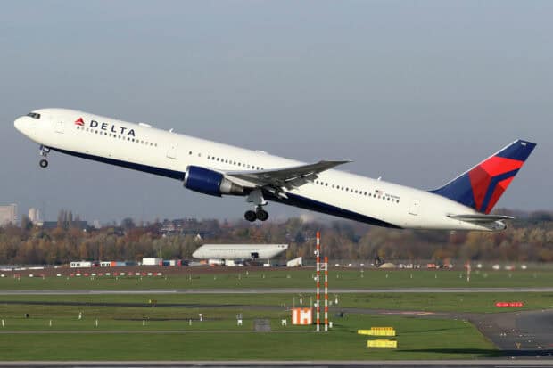 A Delta Air Lines airplane is taking off from the runway with clear skies, HD Desktop Wallpaper