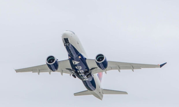 A Delta Air Lines plane is ascending against a cloudy sky, HD Desktop Wallpaper