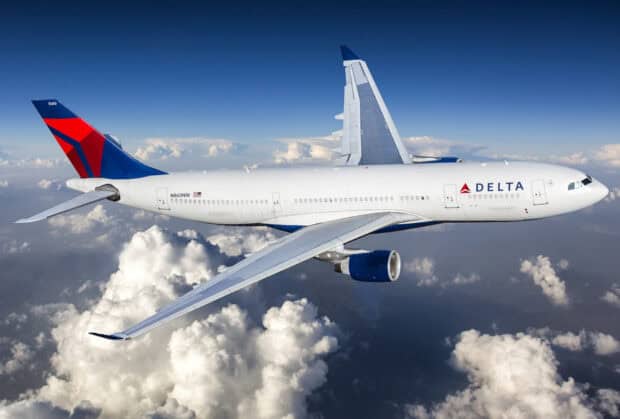A Delta Air Lines airplane soars high above the clouds during flight, HD Desktop Wallpaper