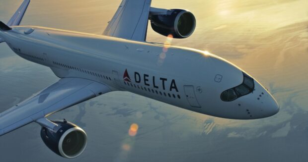 A Delta Air Lines plane flies above the clouds during sunset with a clear sky, HD Desktop Wallpaper