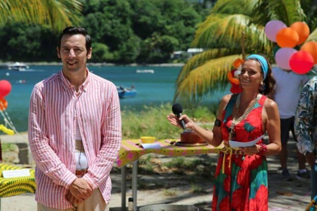 A man and a woman gather outdoors by the sea in Death In Paradise Tv Series Wallpapers, HD Desktop Wallpaper