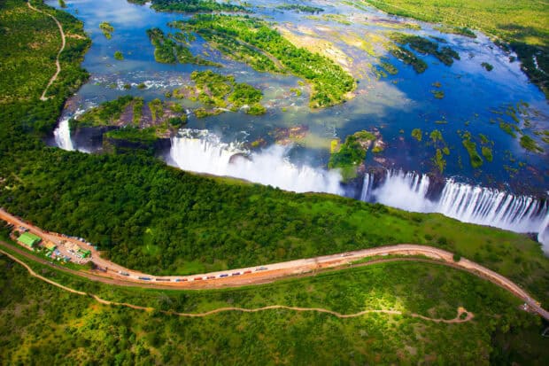 An aerial view of Devils Pool Zambia showcasing waterfalls and surrounding greenery, HD Desktop Wallpaper