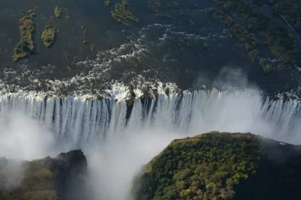 A breathtaking aerial view of Devils Pool Zambia with flowing water and mist, HD Desktop Wallpaper