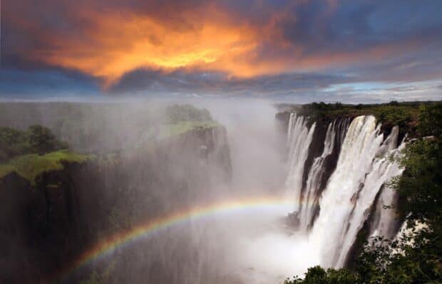 A stunning view of Devils Pool Zambia with a rainbow and dramatic sky, HD Desktop Wallpaper