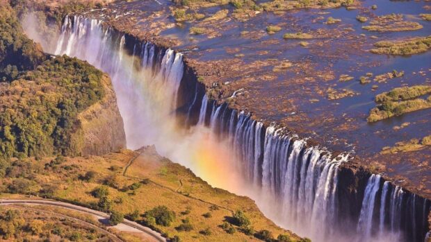 A breathtaking view of Devils Pool in Zambia with cascading waterfalls and surrounding nature, HD Desktop Wallpaper
