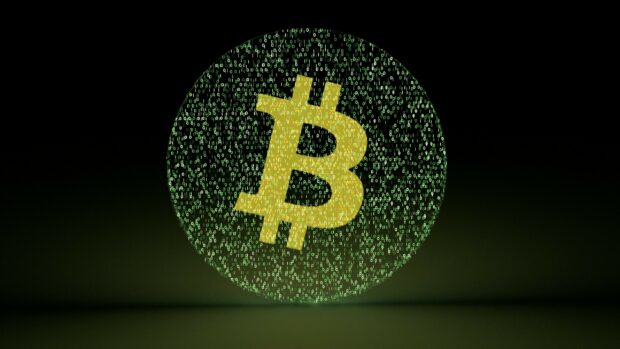 A digital bitcoin symbol is surrounded by streaming binary code in a dark setting, 2K Desktop Wallpaper