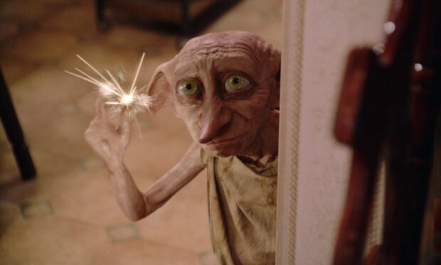 Dobby holds a shining light at his finger tip in a scene from The Chamber of Secrets, HD Desktop Wallpaper