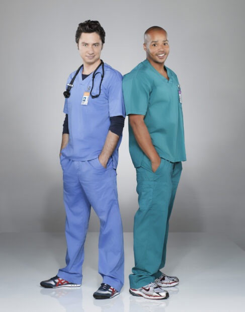 Donald Faison and his co star wear medical scrubs standing back to back, 2K Desktop Wallpaper