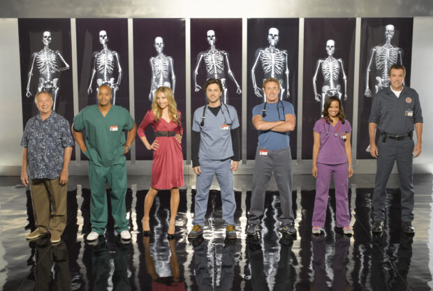 The cast stands in front of skeleton x rays with Donald Faison included in the group, 2K Desktop Wallpaper