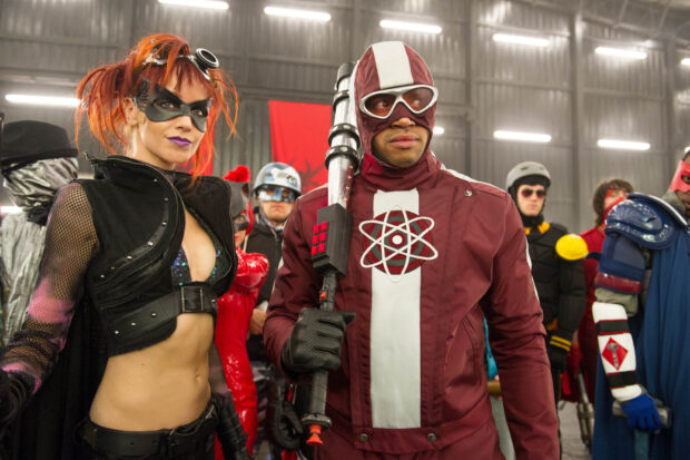 Donald Faison dressed in a red and white superhero costume holding a weapon, HD Desktop Wallpaper