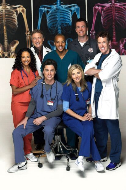 The medical team including Donald Faison poses in front of colorful skeleton illustrations, HD Phone Wallpaper