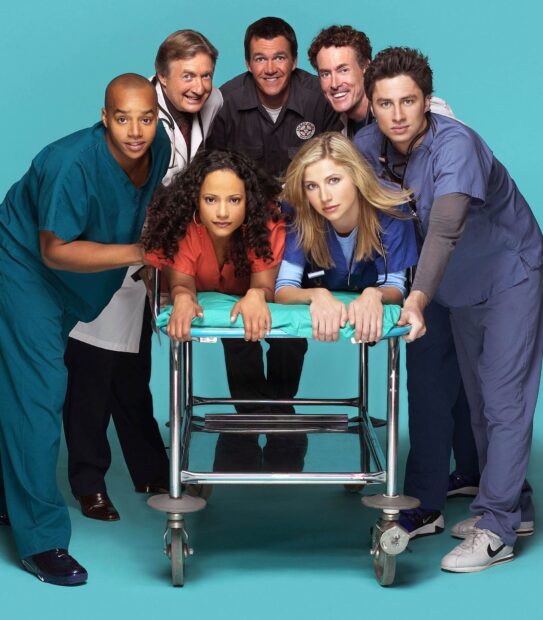 The cast of a medical drama including Donald Faison stand together around a hospital stretcher, HD Desktop Wallpaper