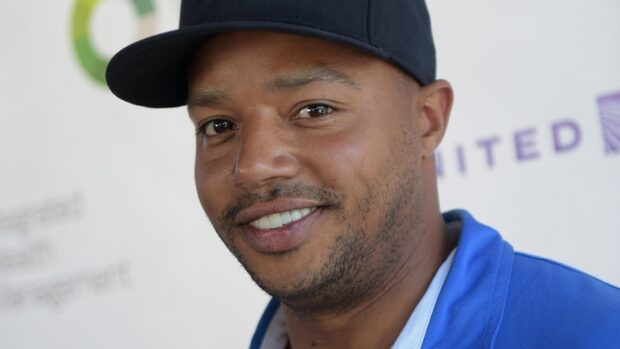 Donald Faison Wallpapers features a close up of a man wearing a black cap and blue jacket, HD Desktop Wallpaper