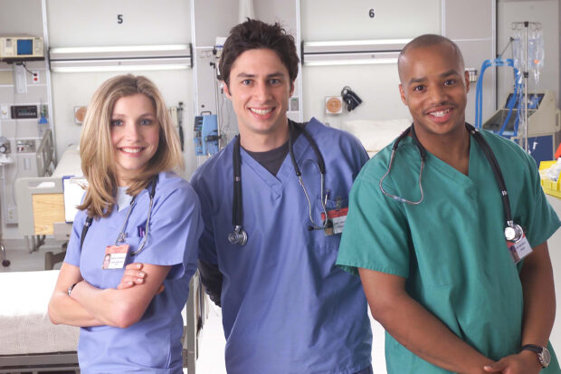 Donald Faison and colleagues smile in hospital setting, HD Desktop Wallpaper