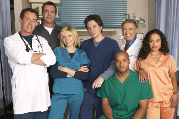 Donald Faison is posing with a group of medical professionals in scrubs and lab coats, HD Desktop Wallpaper