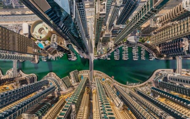 The United Arab Emirates showcases modern skyscrapers along a green marina filled with boats, HD Desktop Wallpaper