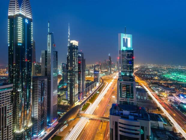 The night view of the United Arab Emirates features modern skyscrapers and illuminated highways, HD Desktop Wallpaper