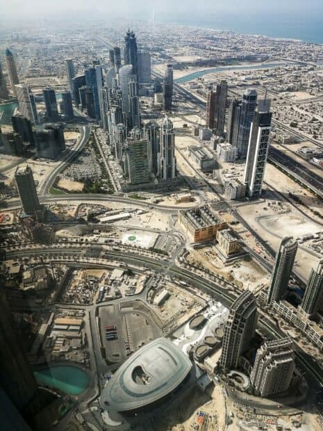 Aerial view of Dubai showing skyscrapers and desert surroundings in the United Arab Emirates, 2K Desktop Wallpaper