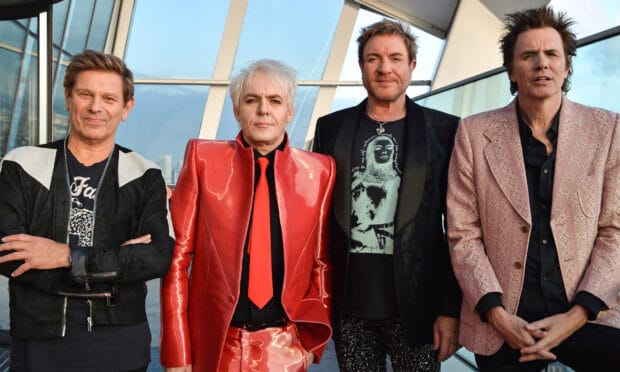 The members of Duran Duran stand side by side wearing stylish outfits, 2K Desktop Wallpaper