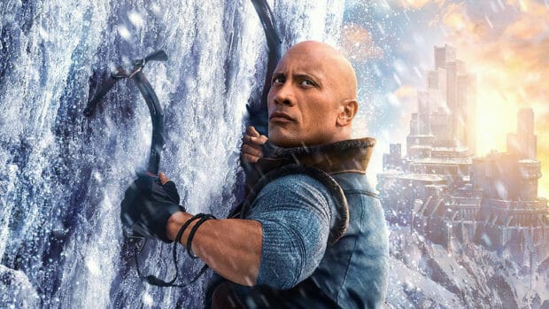 Dwayne Johnson climbing a snowy mountain with ice tools in a winter landscape, 4K Desktop Wallpaper