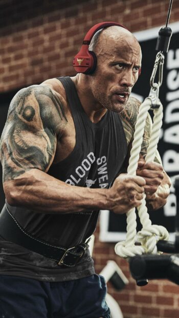 Dwayne Johnson is focused on an intense workout using a rope exercise in the gym, 2K Phone Wallpaper