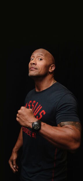 Dwayne Johnson is posing with a confident expression and clenched fist, HD Phone Wallpaper