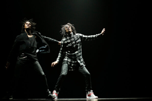Les Twins perform an energetic dance on stage with dramatic lighting, HD Desktop Wallpaper