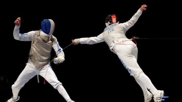 Two fencers compete in a high speed fencing match wearing full protective gear, 4K Desktop Wallpaper