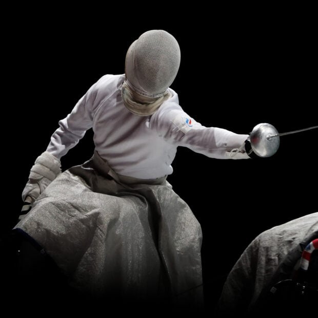 A fencer lunges forward with sword extended during a fencing match, HD Desktop Wallpaper