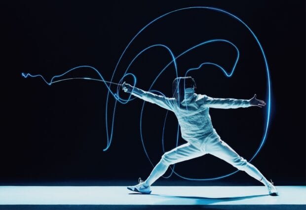 A fencer in white gear performs a dynamic move with glowing light trails around the sword, 2K Desktop Wallpaper
