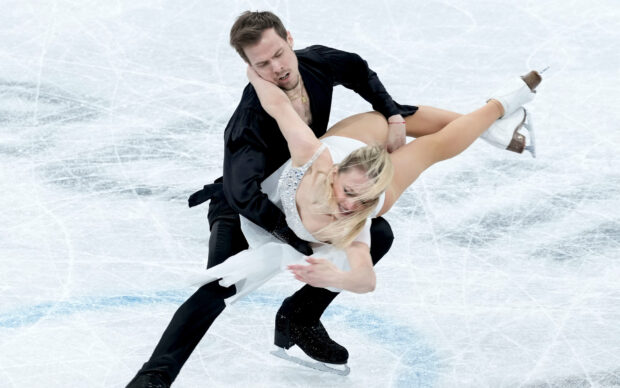 A male and female ice dancing pair performing a complex lift on ice, HD Desktop Wallpaper