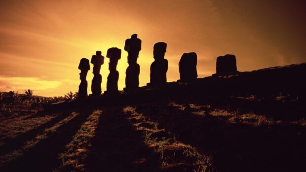 The Easter Island statues cast long shadows during a dramatic sunset, HD Desktop Wallpaper