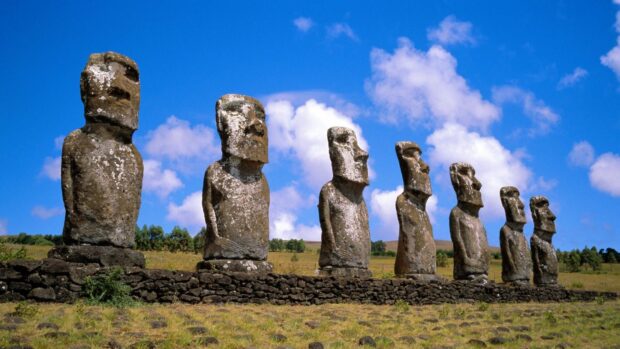 The Easter Island statues stand tall against a bright blue sky with clouds, HD Desktop Wallpaper