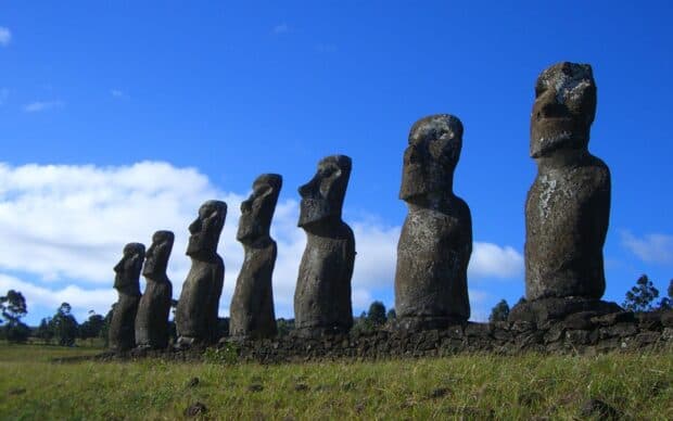 The Easter Island stone statues stand tall against a blue sky with clouds, HD Desktop Wallpaper