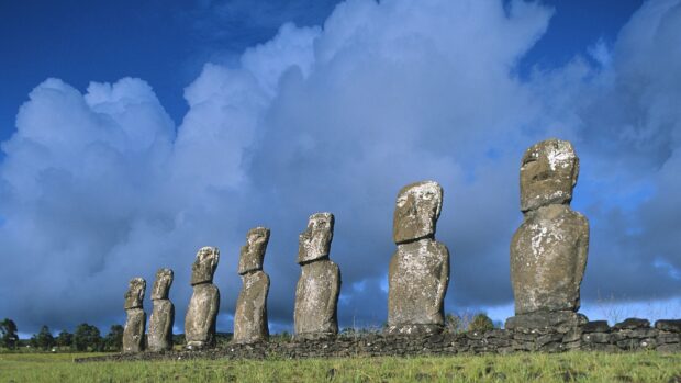 Moai statues stand tall under a cloudy blue sky on Easter Island, HD Desktop Wallpaper