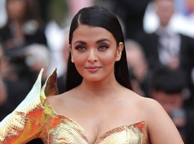 Aishwarya Rai is wearing a stunning golden dress with slicked back hair, 2K Desktop Wallpaper