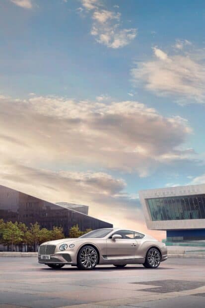 A silver Bentley Continental GT is shown with clear skies and architectural background, HD Mobile Wallpaper